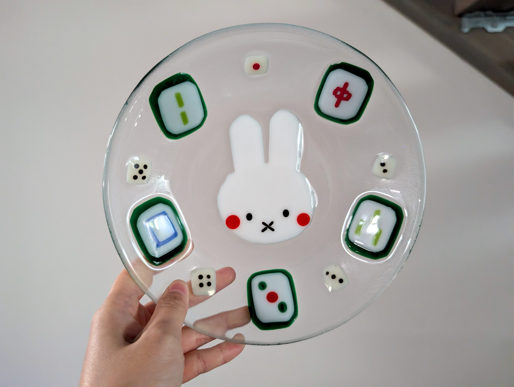 Round fused glass bunny dish held in two hands